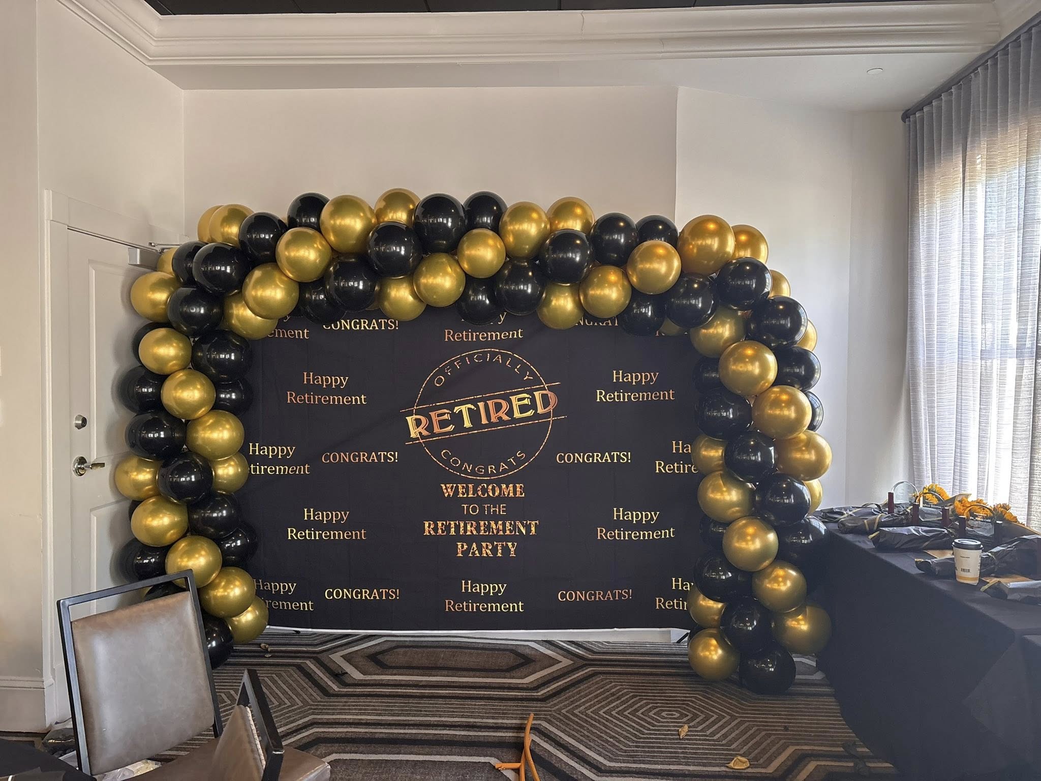 Spiral balloon arch installation for event entryway decor